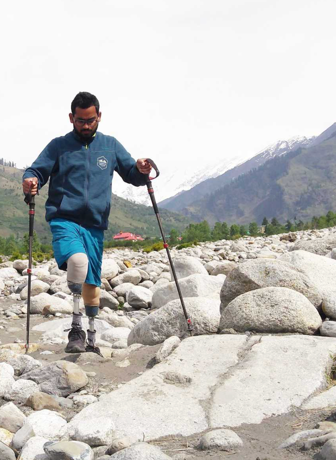 Double-amputee Indian mountaineer and blade-runner Chitrasen Sahu scaling a mountain peak.